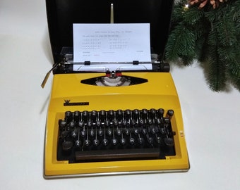 Adler Contessa de Luxe, typewriter vintage yellow with plastic suitcase, manual typewriter, perfectly working, professionally serviced