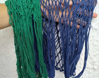 May include: Two string bags, one green and one blue, hanging together. The bags are made of a mesh material and have a knotted design.