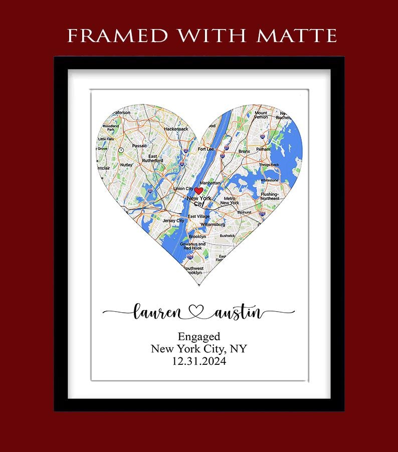 May include: A framed print with a white matte featuring a heart-shaped map of New York City with a red heart icon. Below the map, the text reads: FRAMED WITH MATTE, lauren heart austin, Engaged, New York City, NY, 12.31.2024 in black script and print.