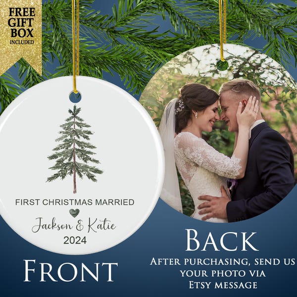 May include: A round white ceramic ornament featuring a green pine tree illustration, the text FIRST CHRISTMAS MARRIED, a small green heart, the names Jackson & Katie, and the year 2024. The reverse side displays a photograph of a couple.