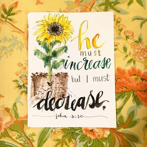 May include: Watercolor painting of a sunflower with roots and the text "He must increase but I must decrease. John 3:30."