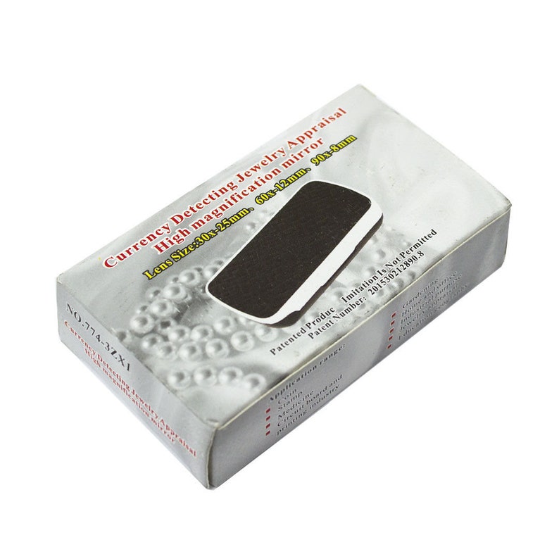 May include: A white box with a black magnifying glass inside. The box has the text "Currency Detecting Jewelry Appraisal High magnification mirror Lens Size: 30x-25mm, 60x-12mm, 90x-8mm NO.774-3ZX1 Currency Detecting Jewelry Appraisal Patent Number: 201530212890.8 Patented Product Imitation Is Not Permitted" printed on it.
