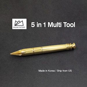 May include: A gold-colored 5 in 1 multi-tool in the shape of a pen. The tool is made by Dream Factory.