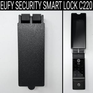 May include: Black Eufy Security Smart Lock C220. The image shows the lock in two parts: the outer case and the lock itself. The lock has a keypad, a keyhole, and the brand name. The outer case is a textured black metal.