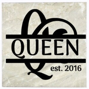 May include: A square, light grey stone tile with a black, stylised letter "Q" with a decorative flourish. The letter is centred above a black line with the word "QUEEN" in white letters. Below the line is the text "est. 2016".