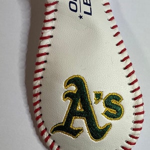 May include: White leather baseball keychain with red stitching and an embroidered green "A's" logo. The keychain has a silver metal ring.