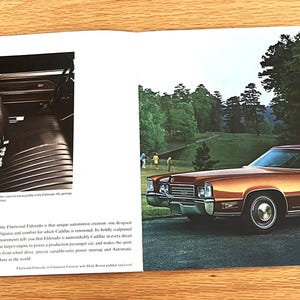 May include: A vintage car advertisement featuring a copper-colored Cadillac Eldorado coupe. The car is parked on a road with a golf course and trees in the background. The interior of the car is shown in a black and white photo on the left.