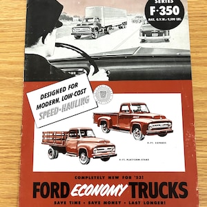 May include: Vintage advertisement for Ford Economy Trucks. The ad features illustrations of red pickup trucks, a semi-truck, and a car on a highway. Text includes "Designed for Modern, Low-Cost Speed-Hauling" and "Ford Economy Trucks."