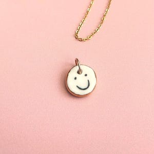 Double-Sided Ceramic Emotional Face Pendant: Gold Lustre Edge