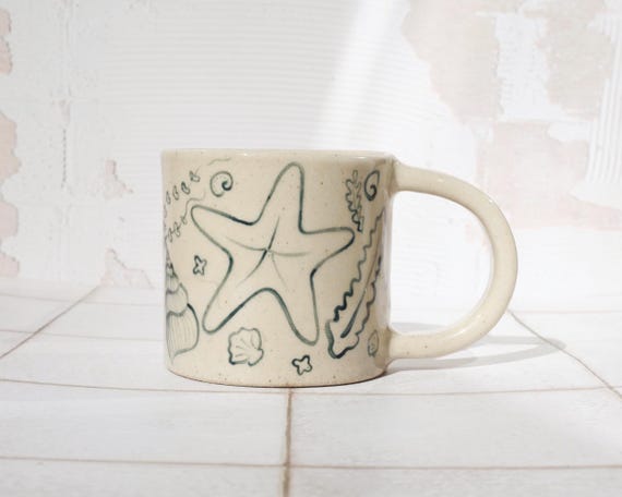 Handmade Stoneware Coffee Mug: 335ml Hand-Painted Shell illustration