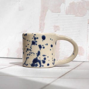 Handmade Stoneware espresso Mug with Splash Blue and Clear Glaze on speckled clay