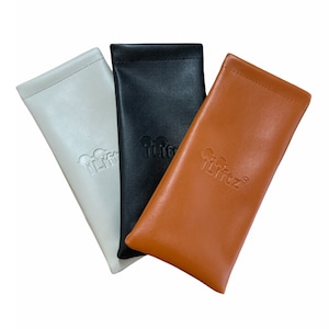 May include: Three leather eyeglass cases in white, black, and brown. Each case has the word "LIFTZ" embossed on the front.