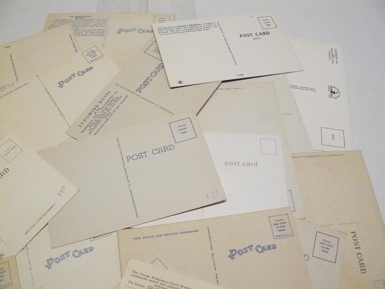 May include: A collection of vintage postcards, some with the words "POST CARD" printed on them. The postcards are in various shades of cream and beige, with some featuring text and images.