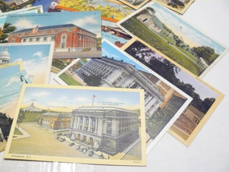 May include: A collection of vintage postcards featuring architectural landmarks. The postcards showcase buildings with detailed facades, including a post office and other structures. The color palette includes shades of beige, blue, and red.