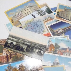 May include: A collection of vintage postcards featuring various architectural landmarks, maps, and scenic views. The postcards showcase buildings, rivers, and cityscapes, with a variety of colors and styles. Some postcards have text, including place names.
