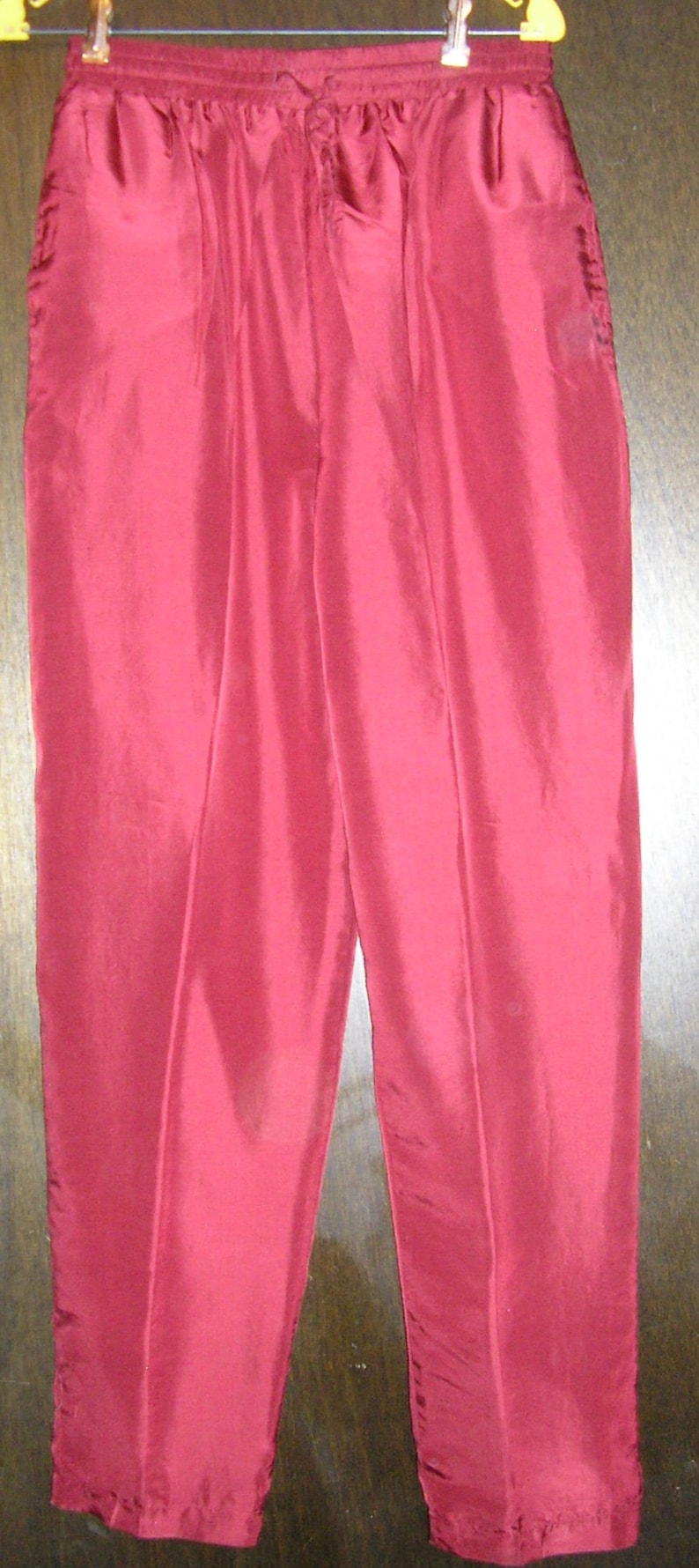 May include: A pair of red sweatpants with a drawstring waist.