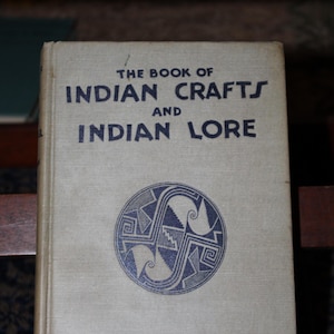 May include: The Book of Indian Crafts and Indian Lore by Julian Harris Salomon. The cover features a blue and white geometric design.