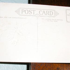 May include: Blank white postcard with the text "POST CARD" printed in the center. The text "THIS SIDE FOR CORRESPONDENCE" is printed on the left side of the card. The text "THE ADDRESS TO BE WRITTEN ON THIS SIDE" is printed on the right side of the card. The text "PLACE POSTAGE STAMP HERE" is printed in a box in the upper right corner of the card.