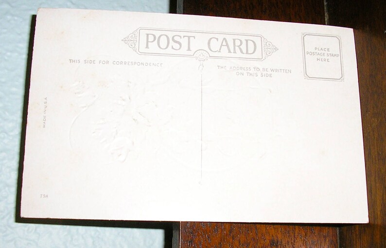 May include: Blank white postcard with the text "POST CARD" printed in the center. The text "THIS SIDE FOR CORRESPONDENCE" is printed on the left side of the card. The text "THE ADDRESS TO BE WRITTEN ON THIS SIDE" is printed on the right side of the card. The text "PLACE POSTAGE STAMP HERE" is printed in a box in the upper right corner of the card.