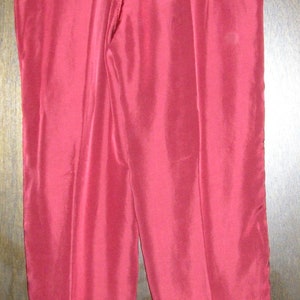 May include: A pair of burgundy sweatpants with a drawstring waist.