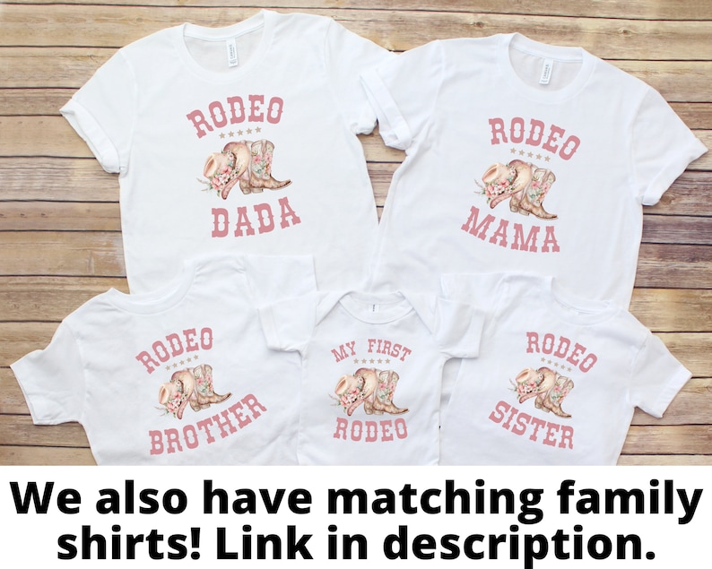 May include: Set of five white t-shirts with pink text and graphics. The shirts say "Rodeo Dada", "Rodeo Mama", "My First Rodeo", "Rodeo Brother", and "Rodeo Sister".