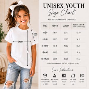 May include: A white t-shirt worn by a child, accompanied by a size chart titled UNISEX YOUTH Size Chart with measurements in inches. The chart lists sizes XS through XL with width, length, and sleeve length, plus care instructions with icons.