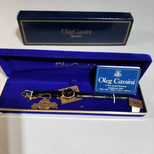 Oleg Cassini Monochrome display Womens  Gold Watch with orig box & black watchband, NOM, see tags, reduced