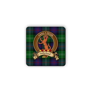 May include: A square coaster featuring a green, blue and red tartan pattern. A circular crest with a lion and the text "SANS PEUR" is in the centre. The text "Sutherland" is on a banner below the crest.