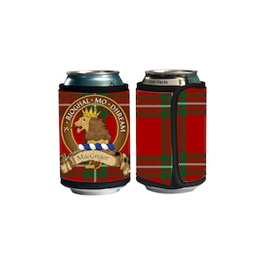 May include: A red, green, and brown plaid can cooler with a black strap. The cooler features a crest with a lion, a crown, and the text "S. RIOGHAL - MO. DHREAM" and "MacGregor".