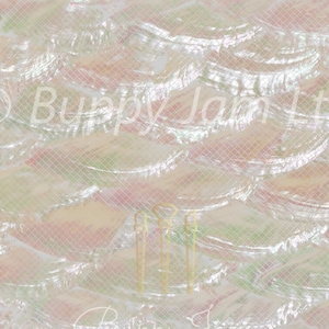 May include: A close-up of iridescent white mother of pearl shell tiles, arranged in a wave pattern. The tiles are arranged in rows, with each row slightly offset from the one above it. The tiles are smooth and shiny, and they reflect light in a variety of colors.