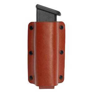 May include: A brown leather magazine pouch with black snaps and a black plastic magazine inside.