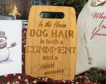 Solid Bamboo Cutting Board engraved with "In this house Dog Hair is both a Condiment and a Fashion Accessory"