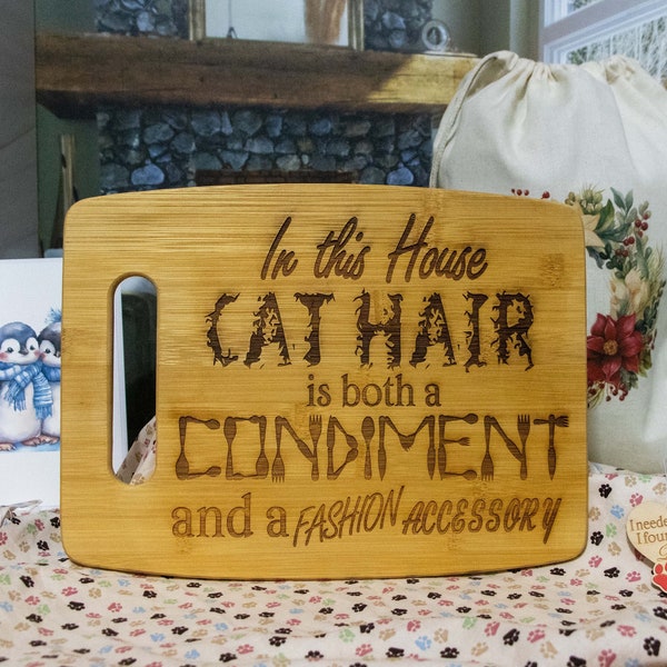 Solid Bamboo Cutting Board engraved with "In this house Cat Hair is both a Condiment and a Fashion Accessory"