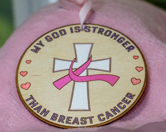 Etched and hand-painted breast cancer ribbon with cross.  My God is Stronger than Breast Cancer. 4-inch ornament.