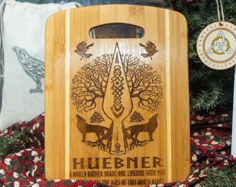 Norse Yggdrasil Ravens wolves thor's hammer engraved into Bamboo with person name on the front banded bamboo cutting board.