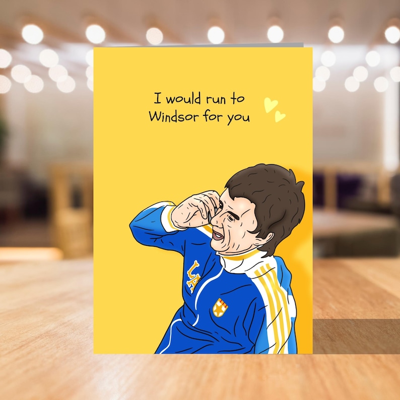 May include: A yellow greeting card with a cartoon illustration of a man in a blue and yellow football kit. The card reads "I would run to Windsor for you" with two small hearts.