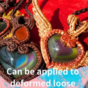 May include: Two handmade macrame heart pendants with iridescent stones. The pendants are made with brown and gold cord and feature a heart-shaped design. The stones are a dark green and purple color with a rainbow sheen.