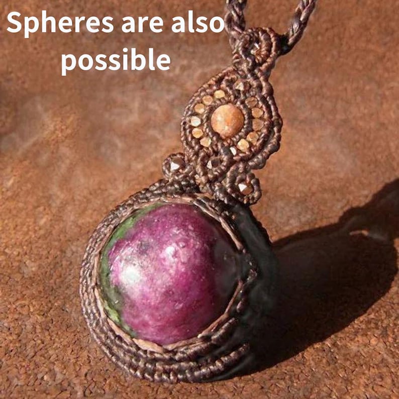 May include: A brown macrame necklace with a round, pink and green gemstone pendant. The pendant is surrounded by brown macrame and the text "Spheres are also possible" is visible in the background.