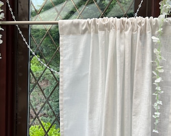 May include: White sheer curtain with a cream colored top hem. The curtain is hanging on a silver curtain rod.