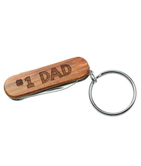 A rosewood multi-tool keychain with custom engraving — pocketable, tactile, and genuinely useful in a way a mug never is.