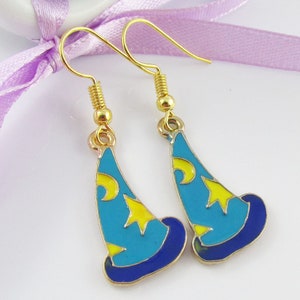 May include: A pair of gold-tone earrings featuring blue and yellow enamel wizard hats. The hats have a crescent moon and stars on them.