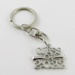 May include: Silver keychain with a graduation cap charm that says "Class of 2022".