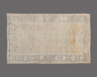 Vintage Turkish Rug 5x9: Handwoven Wool, Faded Lavender Medallion