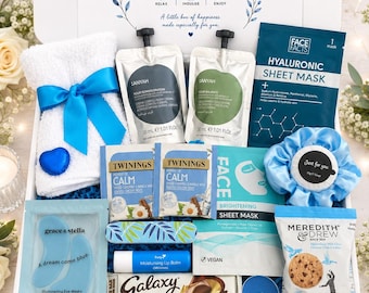 May include: A gift box containing a white towel with a blue ribbon, two Anyah body cream pouches, a Face Facts hyaluronic sheet mask, two Twinings tea bags, a blue scrunchie, a brightening sheet mask, eye masks, lip balm, Galaxy chocolate, and cookies.