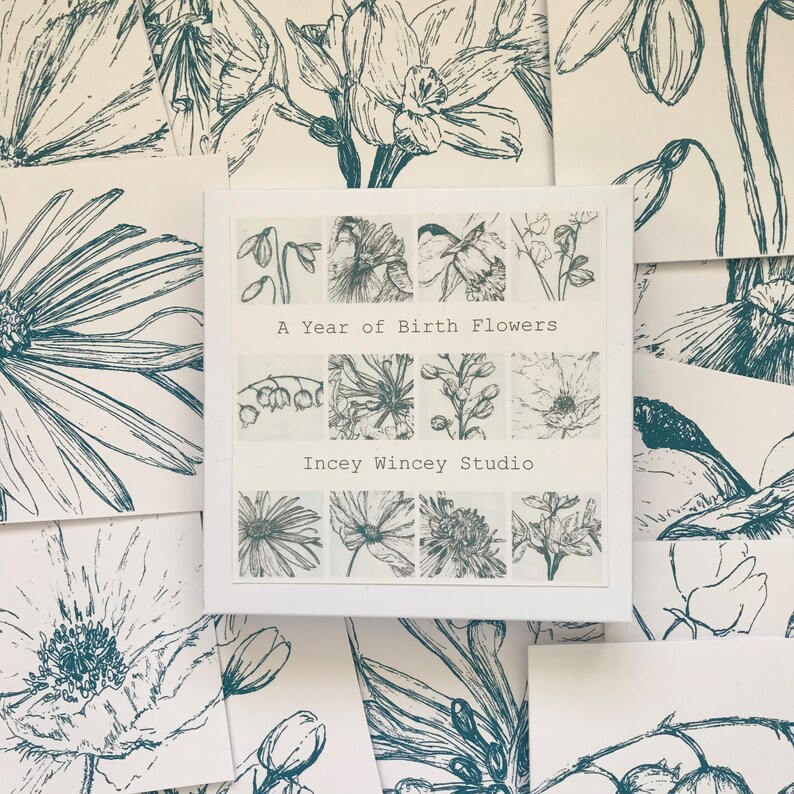 May include: A white card with a grid of 12 black and white flower illustrations. The card has the text "A Year of Birth Flowers" and "Incey Wincey Studio" printed on it.