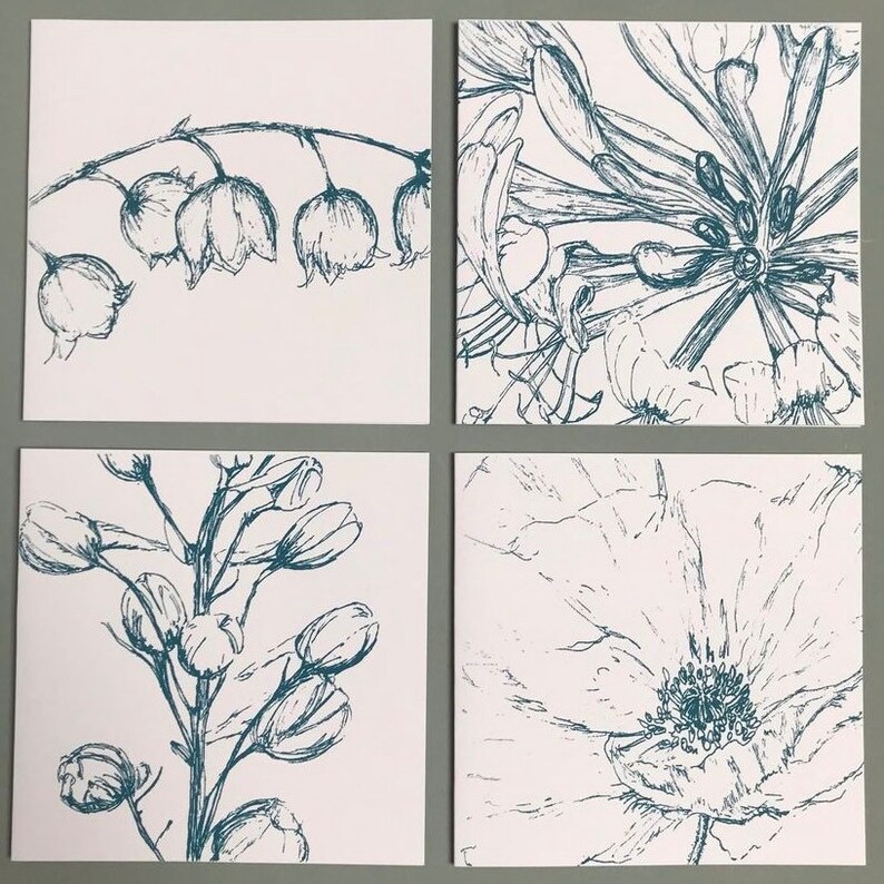 May include: Set of four cards featuring blue ink illustrations of different flowers on a white background. The flowers include lily of the valley, honeysuckle, delphinium, and a poppy.