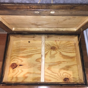 May include: Open wooden storage box with a hinged lid. The interior is made of plywood and has a divider in the middle.