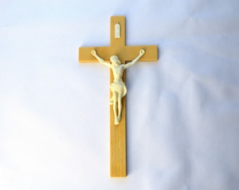 May include: A wooden crucifix with a white plastic figure of Jesus Christ.