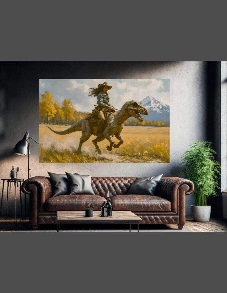 May include: A large canvas print depicts a woman riding a dinosaur through a field. The artwork features a mountain range in the background, with yellow trees and a blue sky. The woman wears a cowboy hat and denim shirt.