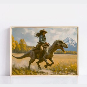 May include: Framed artwork depicting a person riding a dinosaur through a field. The person wears a cowboy hat and denim shirt. The dinosaur is gray and brown. The background features a mountain, trees, and a yellow field.